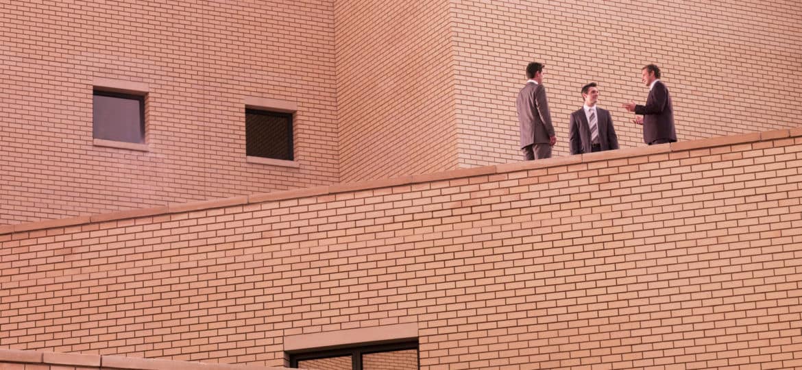 Businessmen meeting on brick building